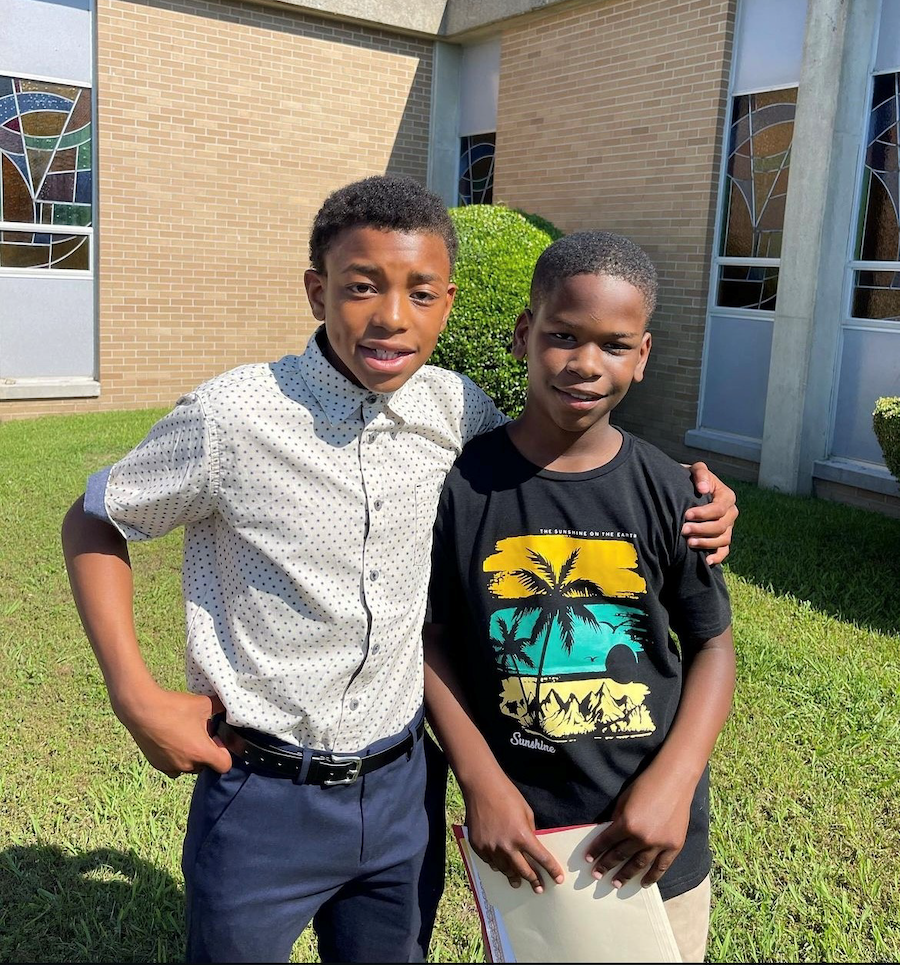 two Y-CAP kids standing next to each other
