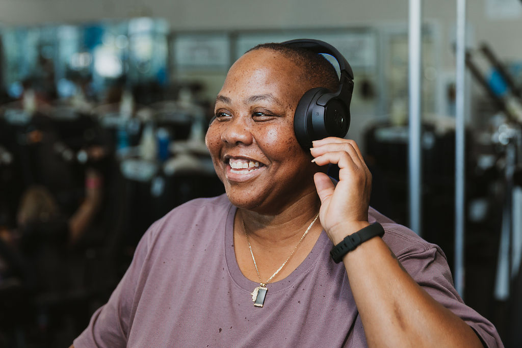 Q smiling adjusting headphones