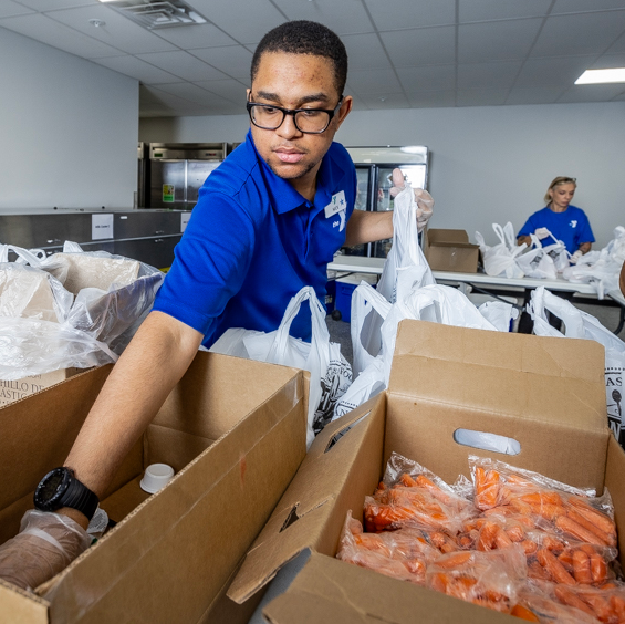 Nick reaching into box to grab item for meal