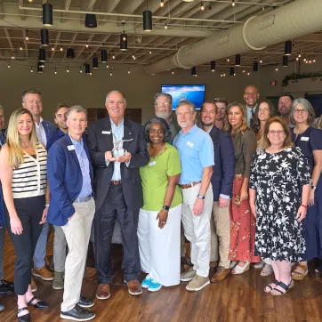 board and staff pose with eagle award