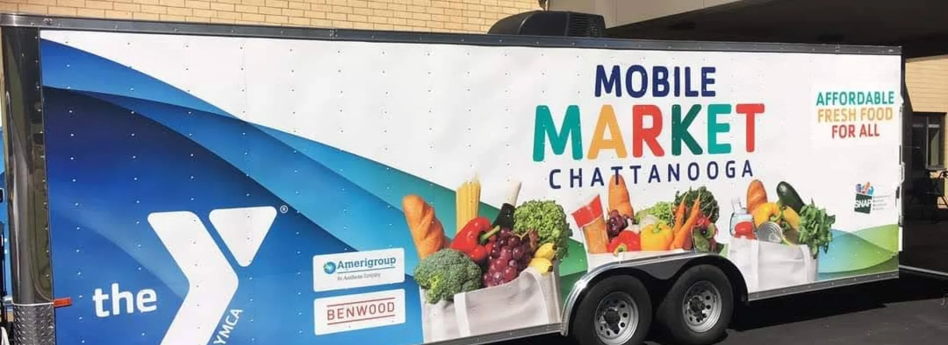 Mobile Market Truck parked outside of a buliding