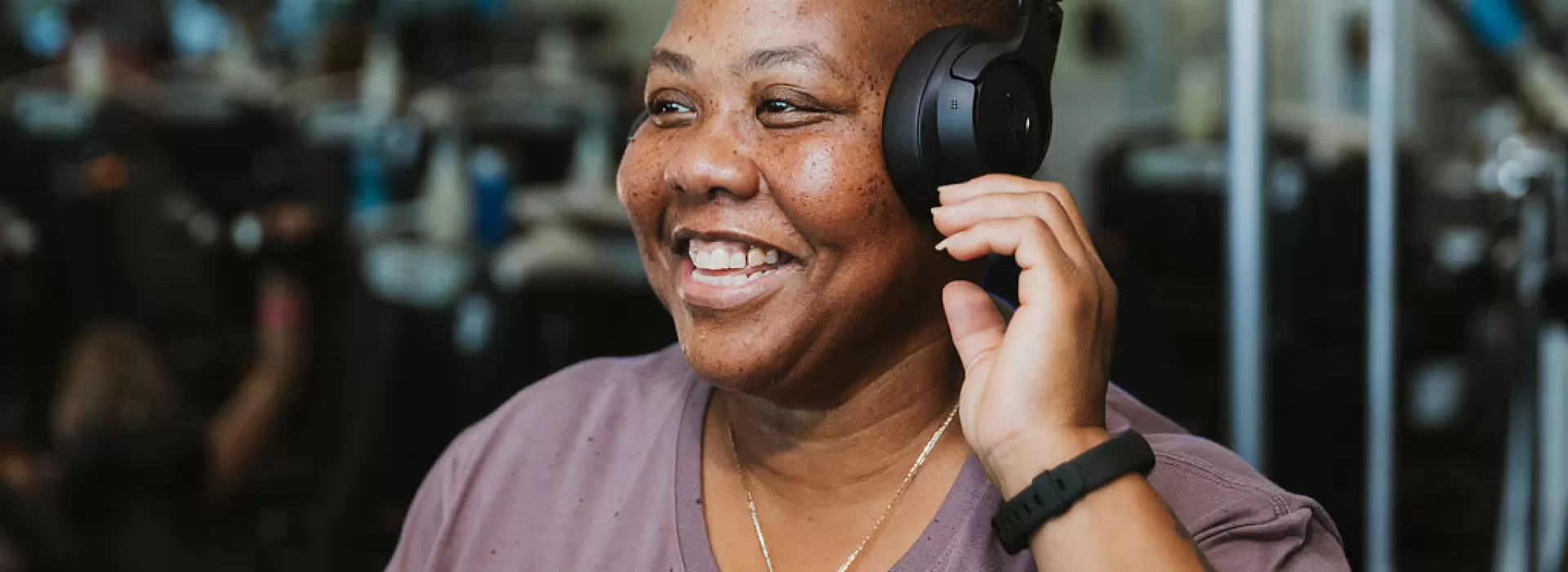 Q smiling adjusting headphones